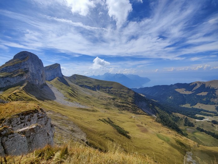 Limestone ridges and alpine pasture, with the lake in the distance.